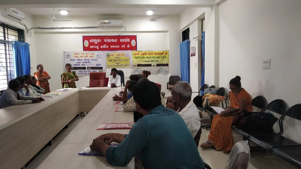 WGWLO paralegal Parulben Kolipatel (in green sari) addresses village leaders in Ahmedabad district, Gujarat.