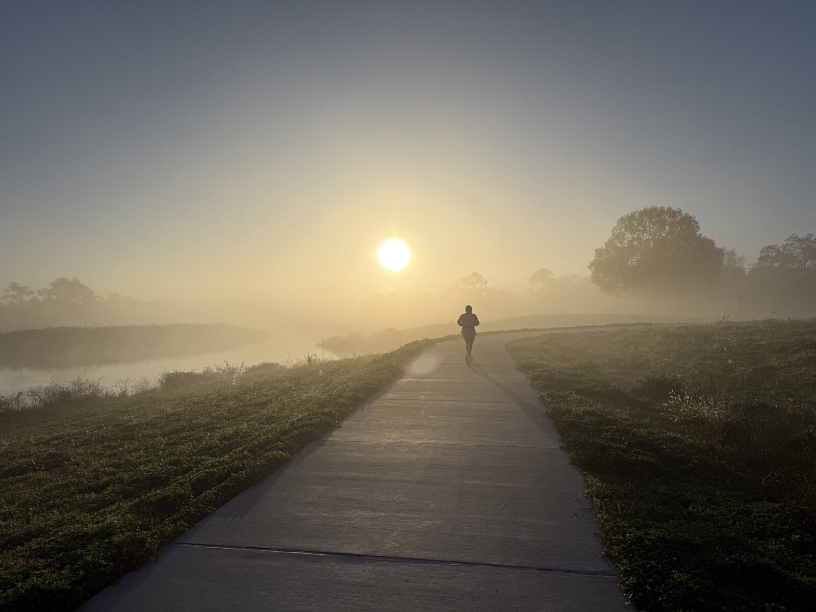 A runner in fog at Exploration Green.