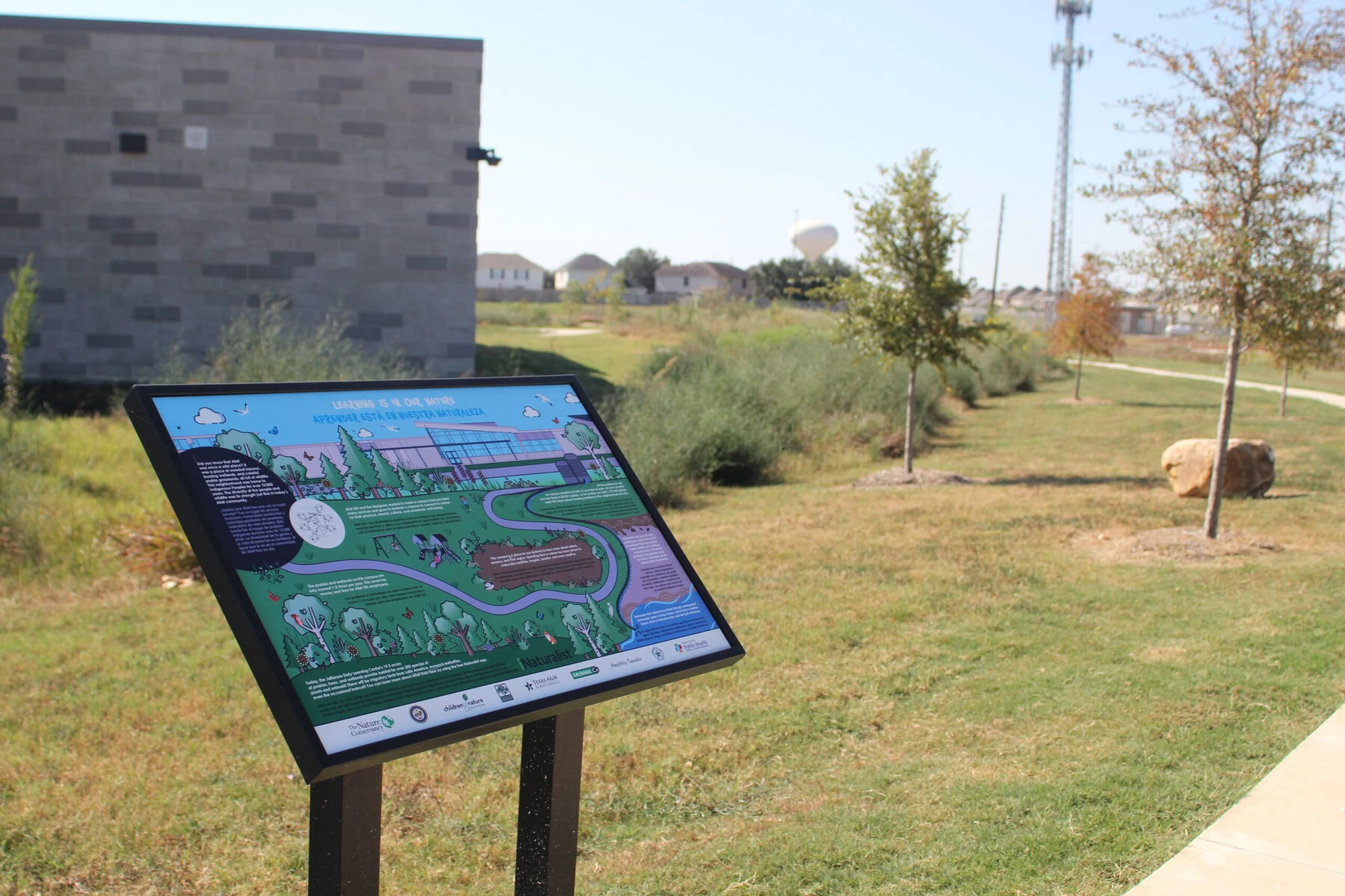 A sign at the front of Jefferson Early Learning Center teaches children about the surrounding land, which was designed to withstand floods and heat. 