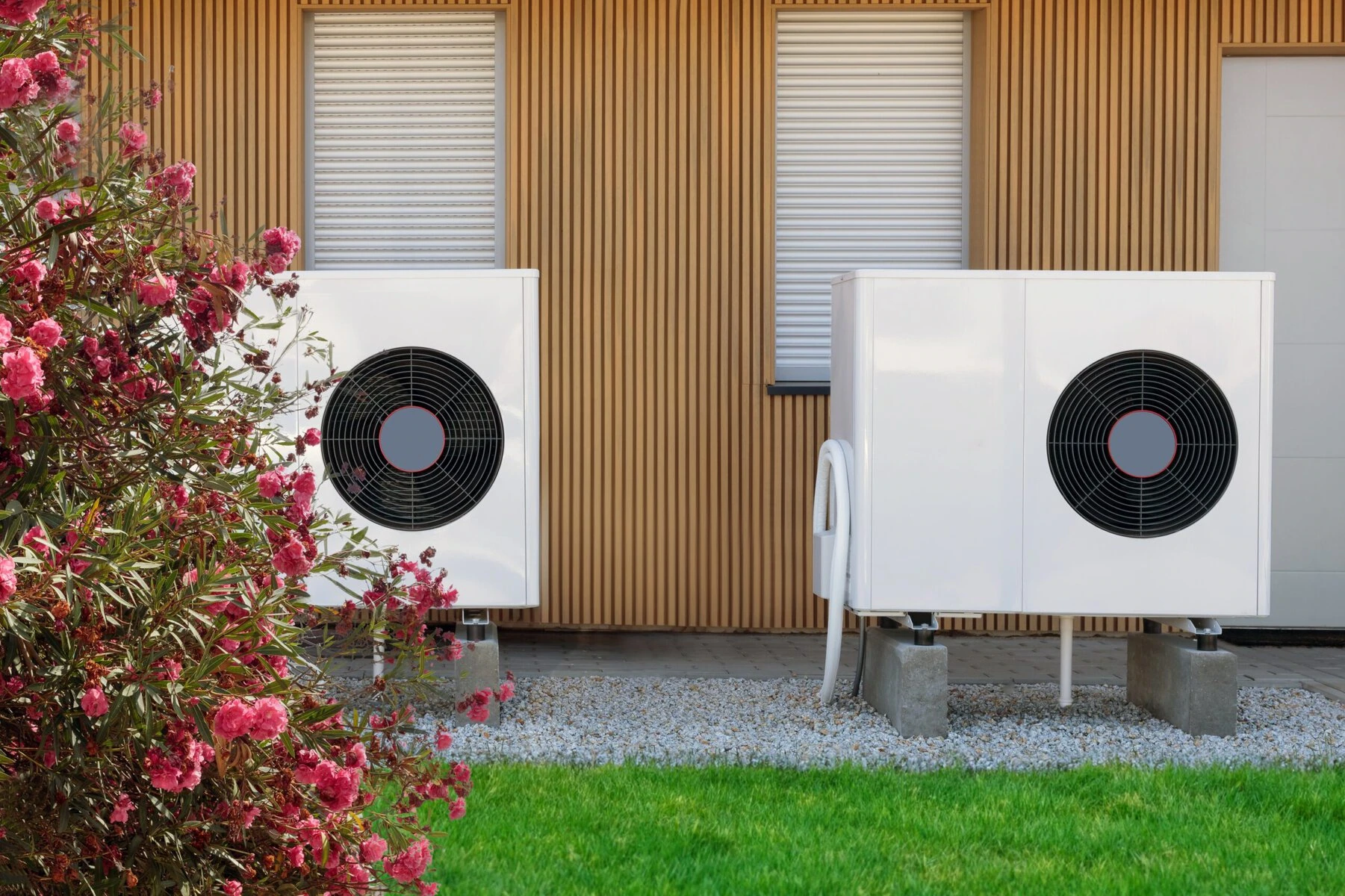 Two heat pumps outside a modern home.