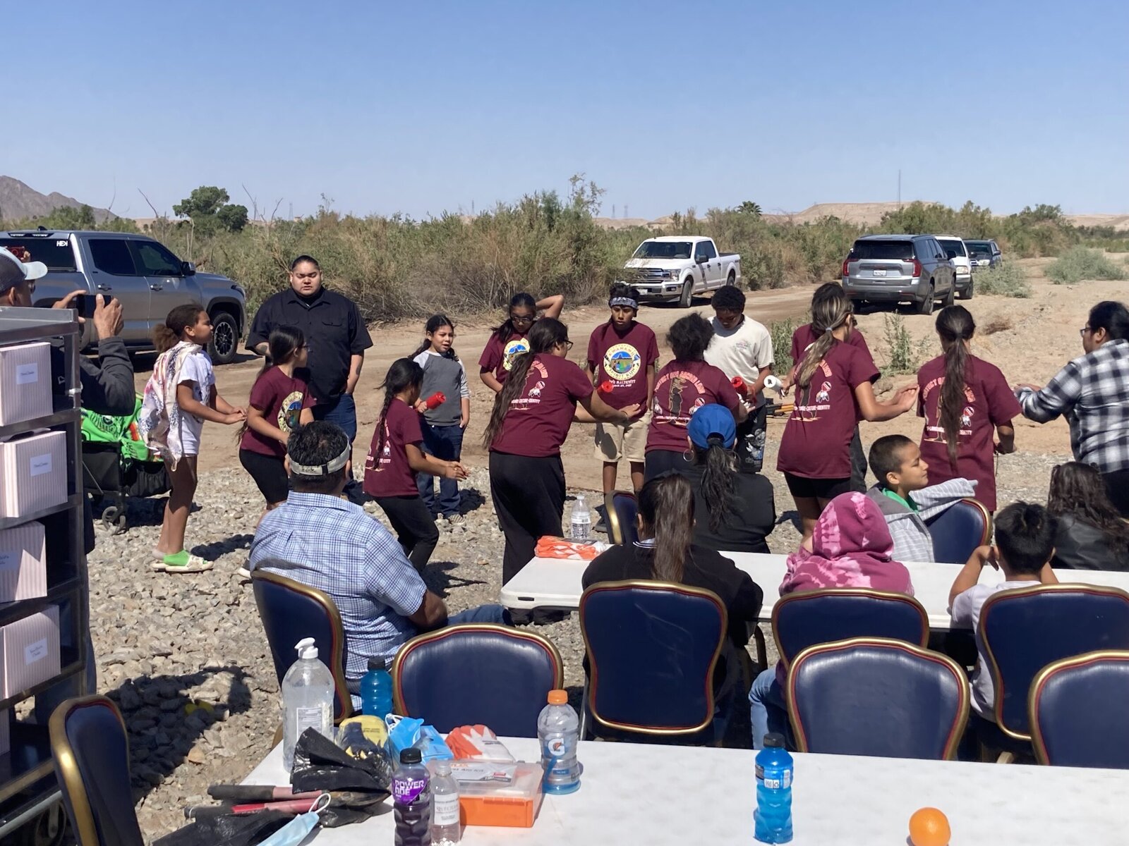 San Pasqual High School students at an outdoor event. They are dancing in a circle.