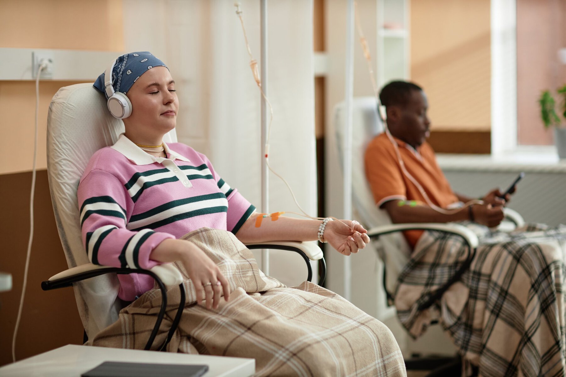 A stock image of two chemotherapy patients listening to music.