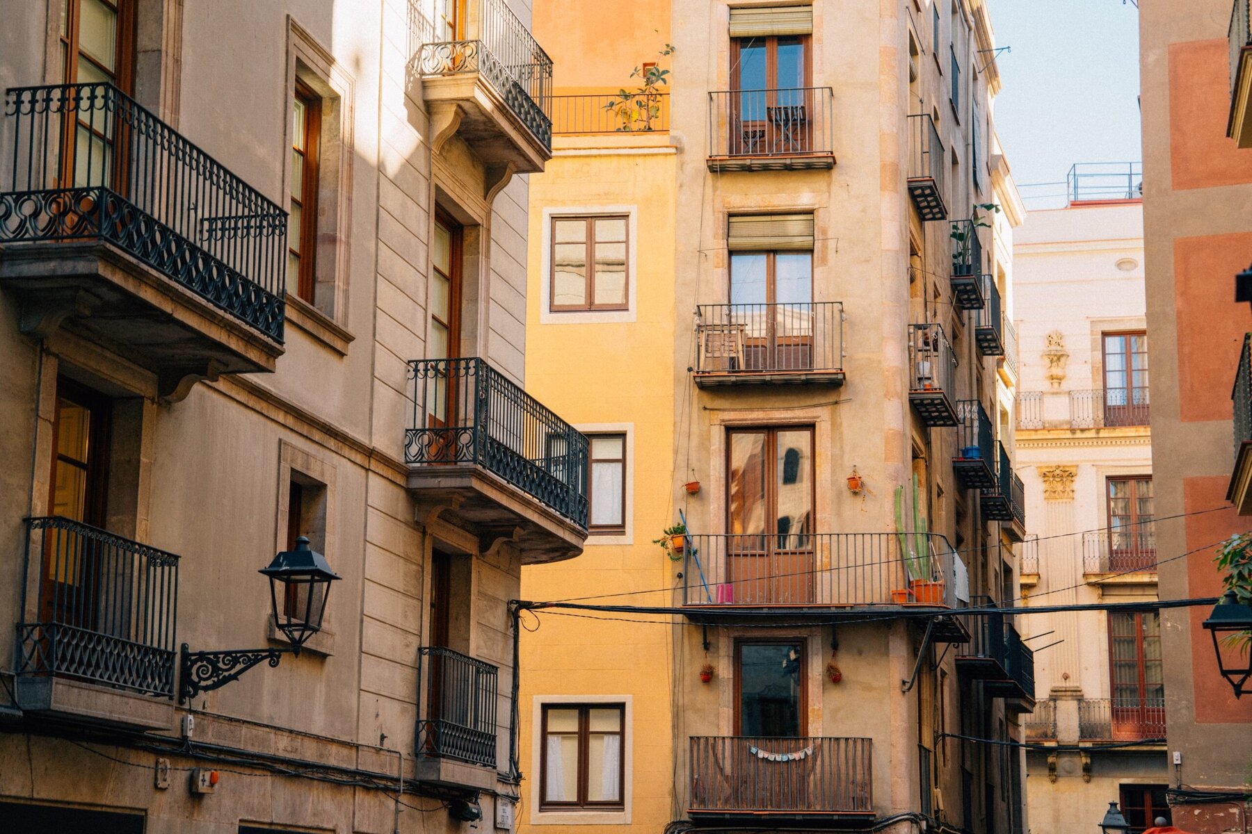 A view of apartment facades with small balconies in Barcelona.